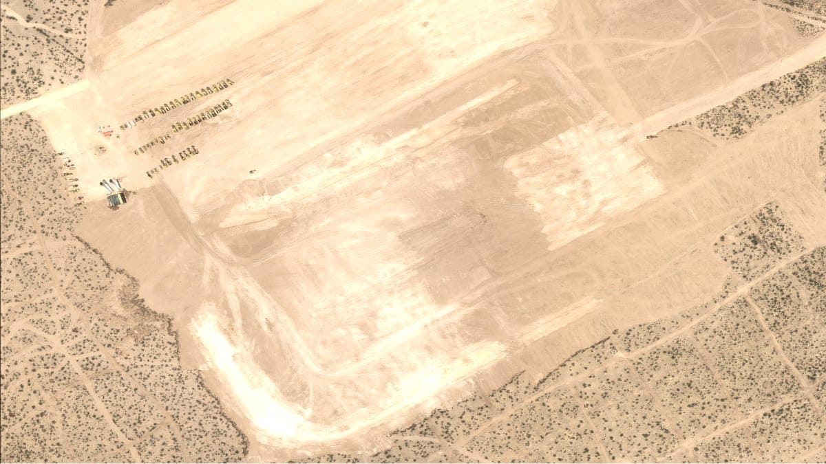 An aerial view of a cleared desert site in West Texas, marked out with access tracks