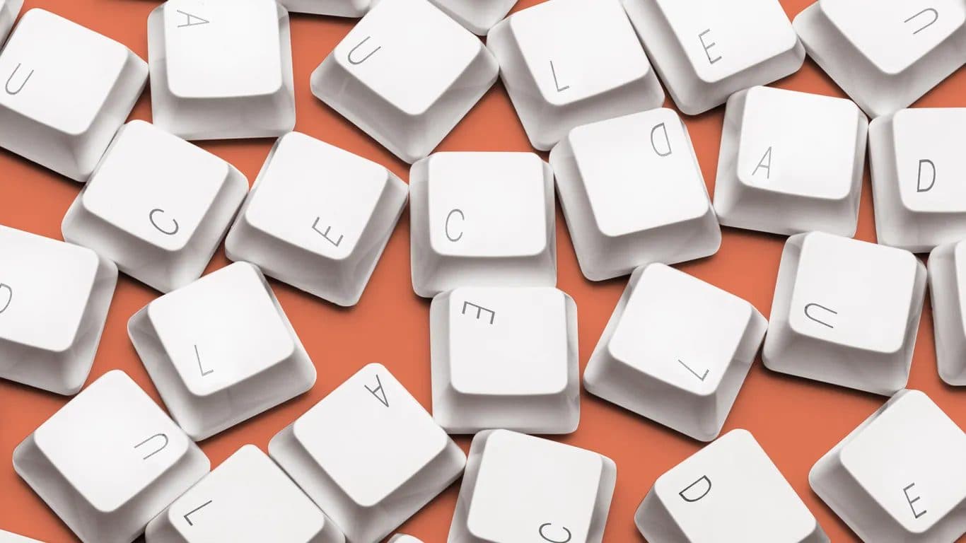 Scattered white keyboard keycaps on an orange background.