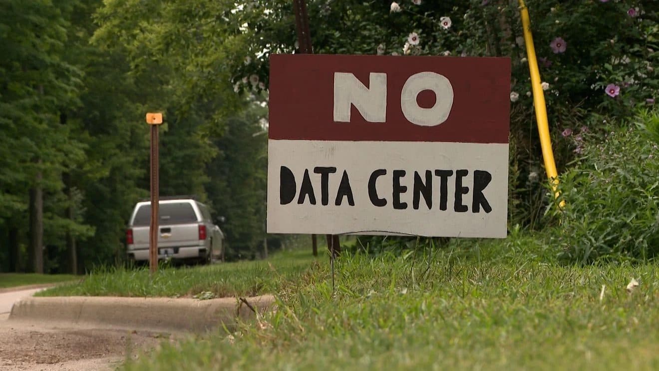 A hand-painted 'NO DATA CENTER' sign beside a rural road.