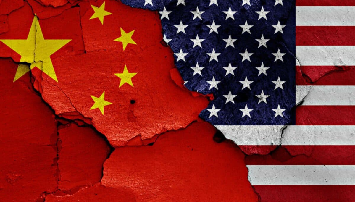 The Chinese and American flags painted on a cracked plaster wall, the fissure running between them