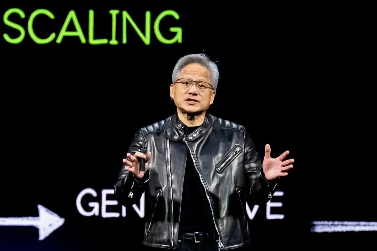 Nvidia chief executive Jensen Huang speaking on stage in front of a screen reading SCALING