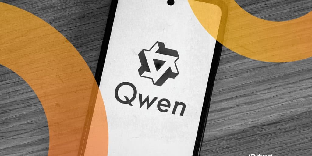 O logotipo e a marca Qwen exibidos em uma tela de smartphone sobre uma superfície de madeira