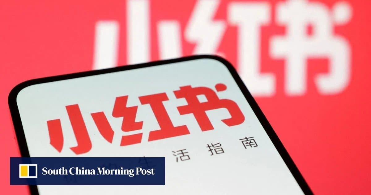 A smartphone showing the Xiaohongshu (RedNote) app logo against the company's red branding