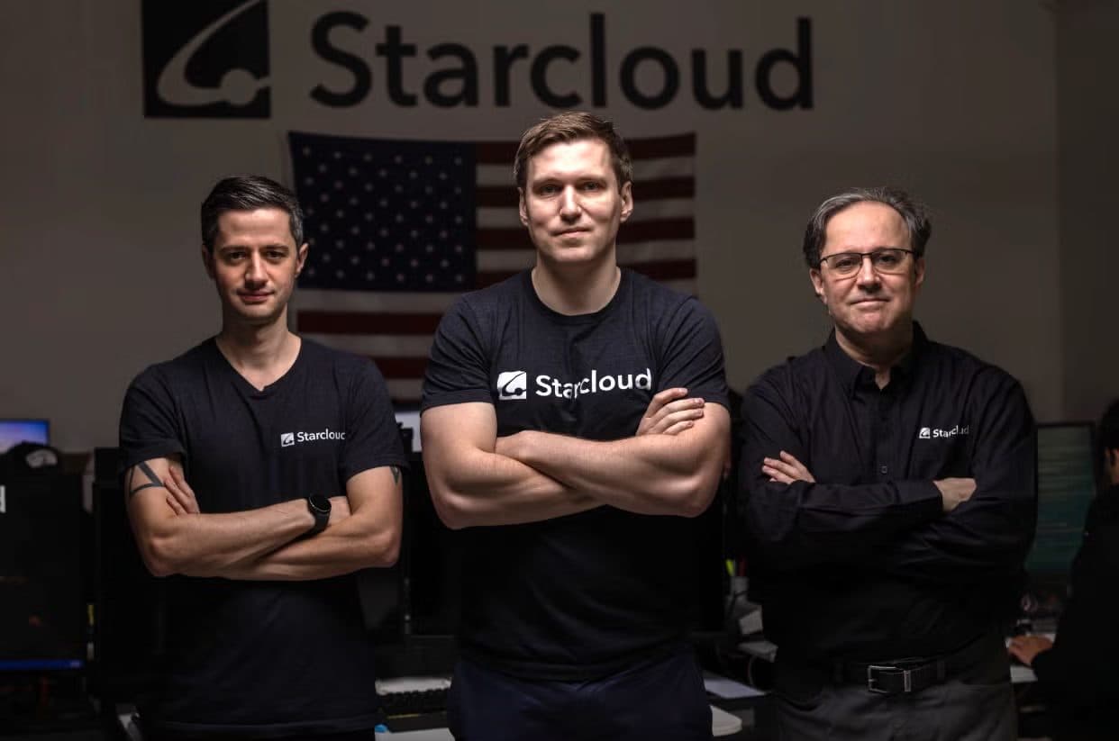 Starcloud's three founders standing in front of a Starcloud sign and a US flag.