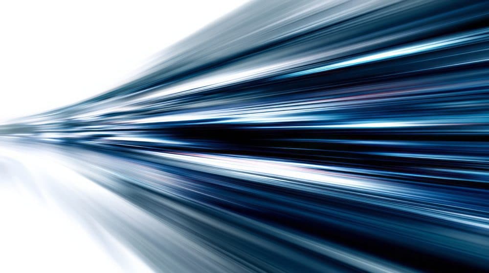 Abstract graphic of blue and white light streaks converging toward a point, suggesting motion.